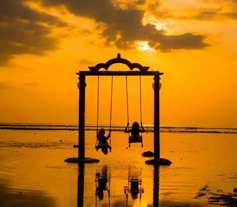 Beautifull Gate with girls swing above ocean sunset. View from Gili island, Trawangan,